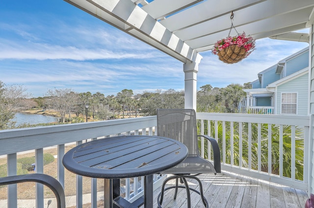 exterior space featuring a water view and a pergola