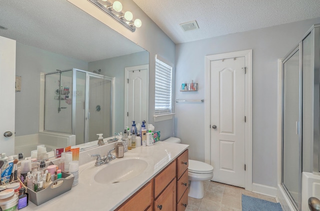 bathroom with vanity, a shower stall, visible vents, and a textured ceiling