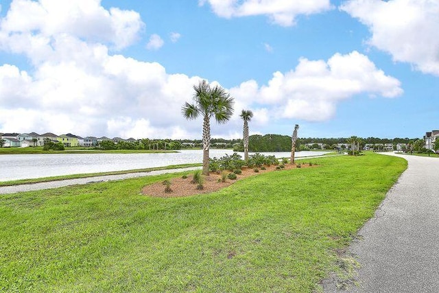 exterior space featuring a yard and a water view