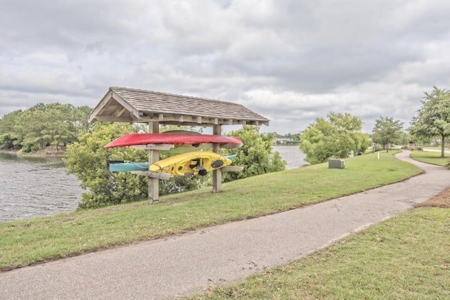 view of home's community with a yard and a water view