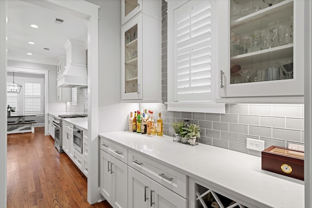 3739 Goodwater St, Mount Pleasant, SC 29466 - kitchen featuring high end stove, white cabinetry, crown molding, decorative backsplash, and glass insert cabinets