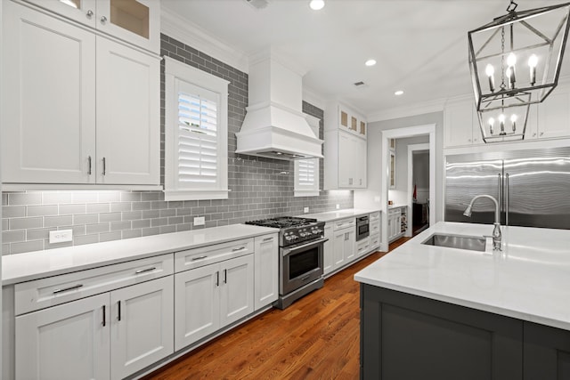 3739 Goodwater St, Mount Pleasant, SC 29466 - kitchen with premium appliances, a sink, ornamental molding, light countertops, and white cabinets