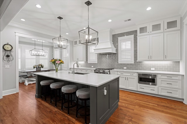 3739 Goodwater St, Mount Pleasant, SC 29466 - kitchen with a chandelier, a sink, premium range hood, crown molding, and light countertops