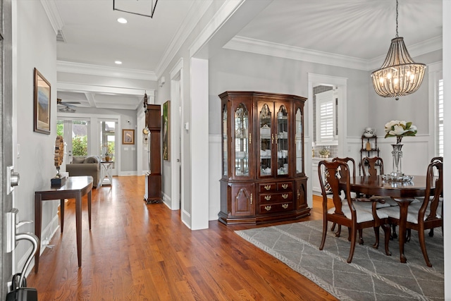 3739 Goodwater St, Mount Pleasant, SC 29466 - dining space featuring a chandelier, coffered ceiling, dark wood finished floors, crown molding, and recessed lighting