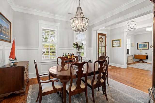 3739 Goodwater St, Mount Pleasant, SC 29466 - dining room with a chandelier, wood finished floors, crown molding, and a wainscoted wall