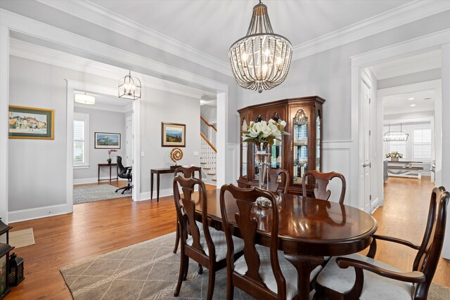 3739 Goodwater St, Mount Pleasant, SC 29466 - dining space featuring a chandelier, healthy amount of natural light, stairs, wood finished floors, and crown molding