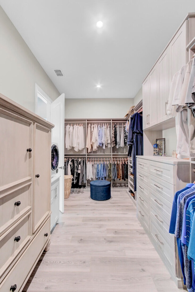 walk in closet featuring light hardwood / wood-style flooring