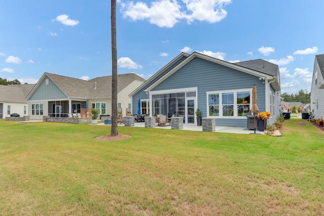 back of property featuring a yard and a patio