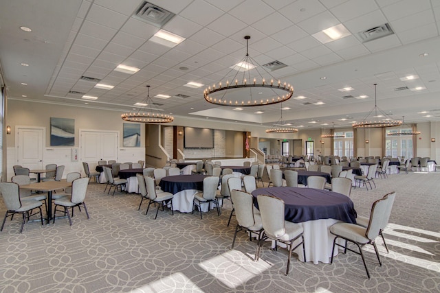 dining space with a paneled ceiling, carpet, and ornamental molding