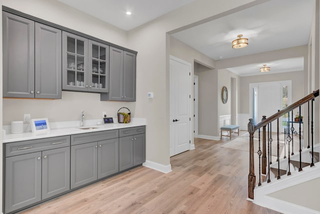 kitchen featuring gray cabinetry, sink, and light hardwood / wood-style floors