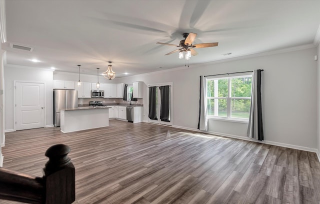 unfurnished living room featuring a ceiling fan, visible vents, crown molding, recessed lighting, and dark wood-type flooring