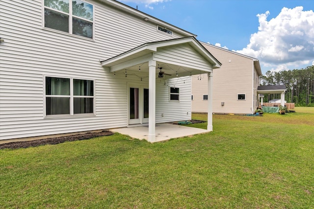 rear view of house featuring a lawn, a patio, and ceiling fan