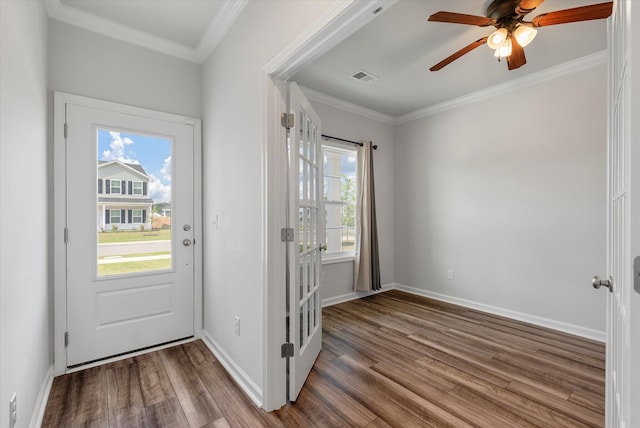 doorway featuring ceiling fan, visible vents, ornamental molding, and wood finished floors