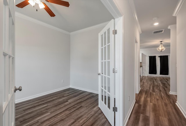 hall featuring crown molding, baseboards, dark wood-style flooring, and visible vents