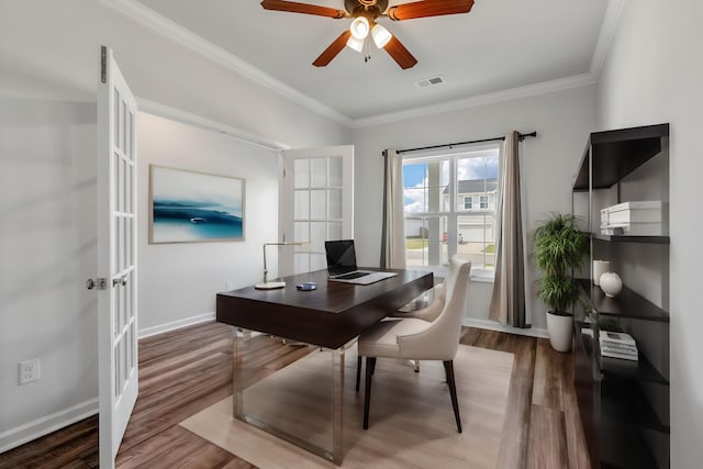 office area with crown molding, french doors, a ceiling fan, wood finished floors, and visible vents