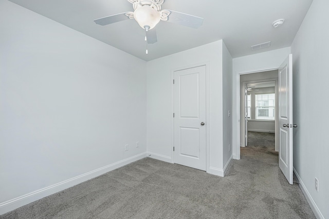 unfurnished bedroom featuring visible vents, baseboards, and carpet flooring