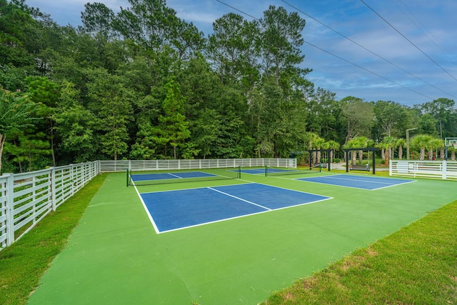 view of sport court featuring fence