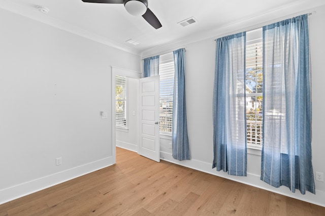 unfurnished room featuring light wood-type flooring, ceiling fan, and crown molding