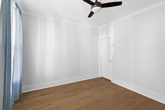 unfurnished room with ceiling fan, dark wood-type flooring, and ornamental molding