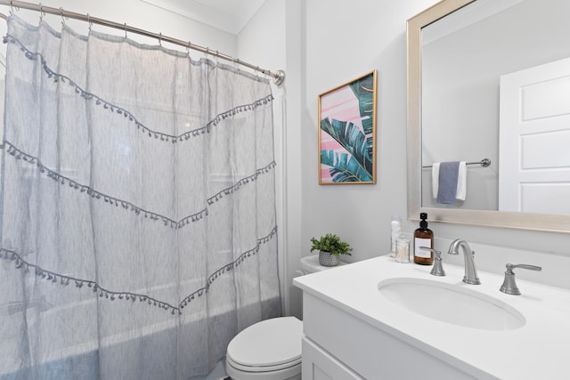 bathroom featuring vanity, ornamental molding, and toilet