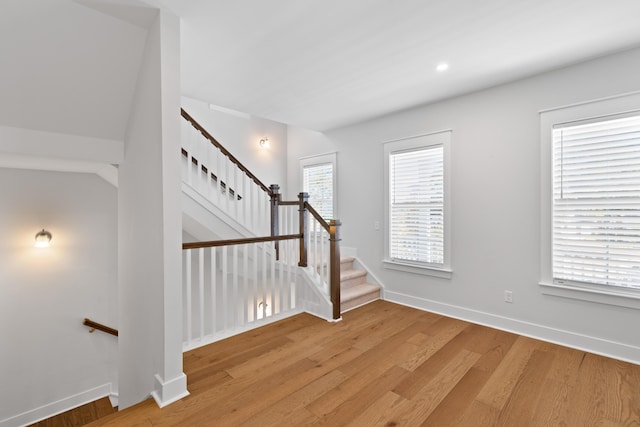 staircase with hardwood / wood-style flooring and plenty of natural light