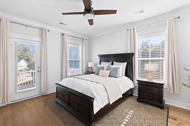 bedroom with access to exterior, ceiling fan, and hardwood / wood-style floors