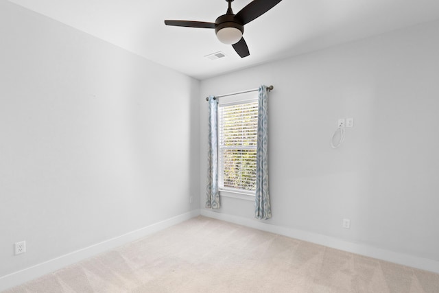 unfurnished room with ceiling fan and light carpet