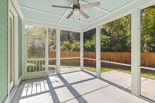 unfurnished sunroom with ceiling fan