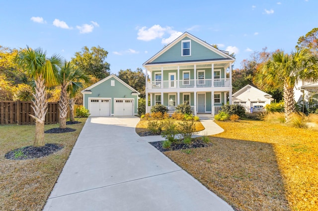 view of front facade with a front yard, a porch, a garage, and an outdoor structure