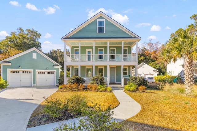 view of front of house with a porch, a garage, and an outbuilding