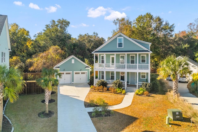 view of front of house with a porch, a garage, a front lawn, and an outdoor structure