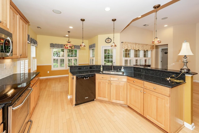 kitchen with appliances with stainless steel finishes, a sink, light wood-type flooring, light brown cabinetry, and baseboards