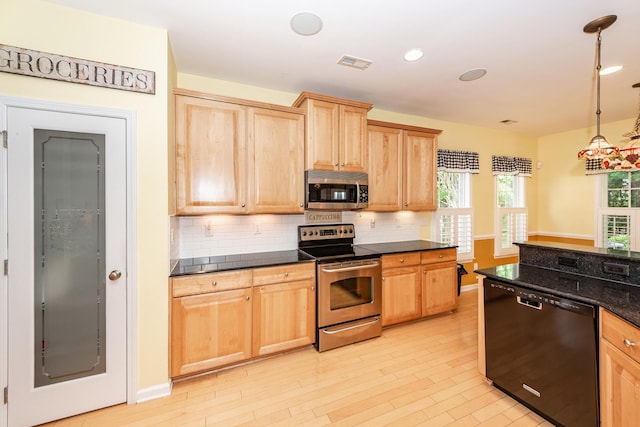 kitchen featuring appliances with stainless steel finishes, light brown cabinetry, backsplash, and recessed lighting