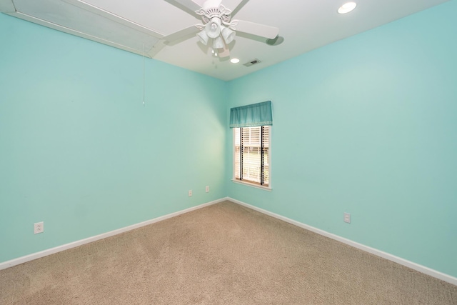 carpeted spare room with attic access, a ceiling fan, recessed lighting, and baseboards