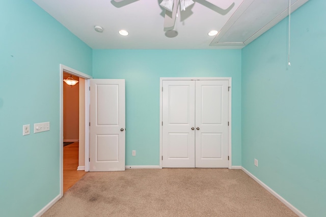 unfurnished bedroom with attic access, carpet flooring, baseboards, a closet, and recessed lighting