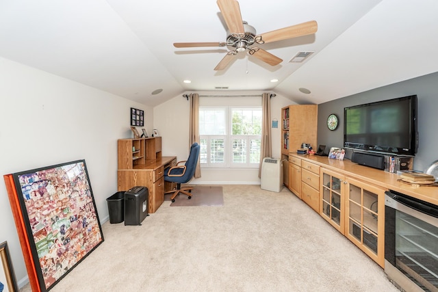 office space featuring wine cooler, light carpet, vaulted ceiling, a ceiling fan, and baseboards