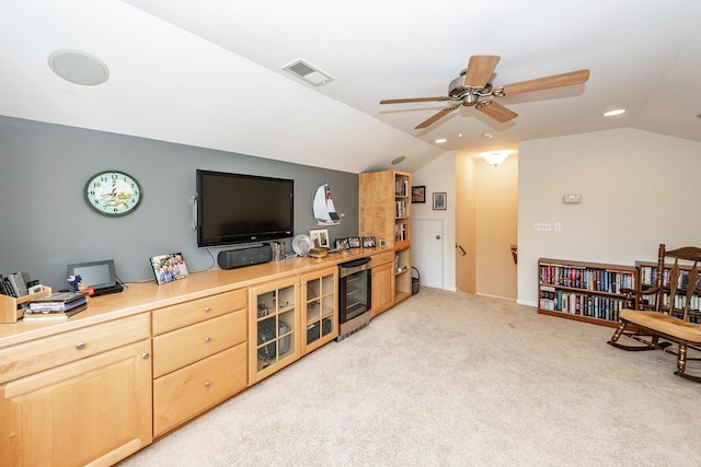 living room with lofted ceiling, wine cooler, ceiling fan, and light carpet