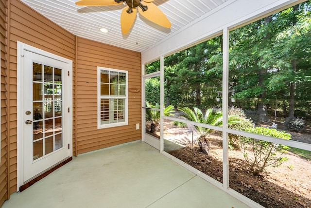 unfurnished sunroom with ceiling fan