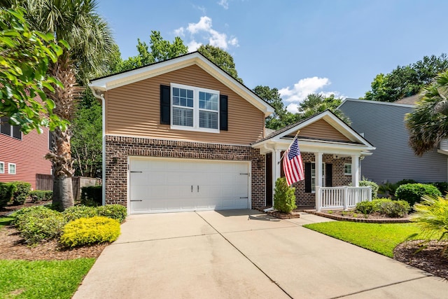 traditional-style home with brick siding, a porch, driveway, and an attached garage