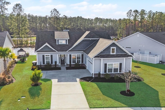 craftsman house with a garage, covered porch, and a front lawn