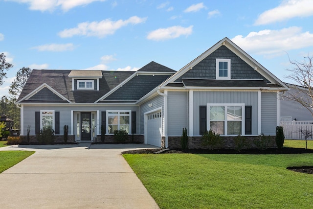 craftsman house with a garage and a front yard