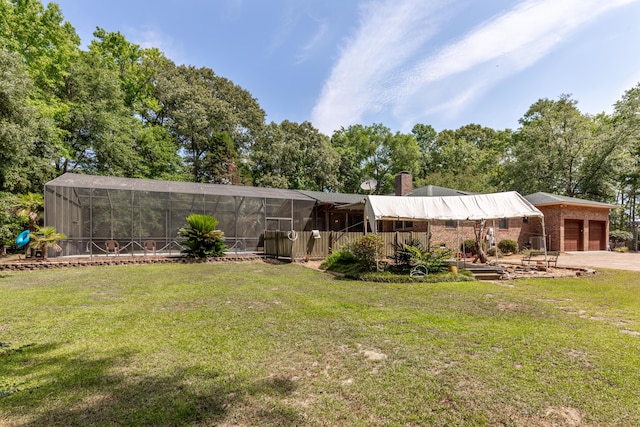 view of yard featuring a garage and glass enclosure