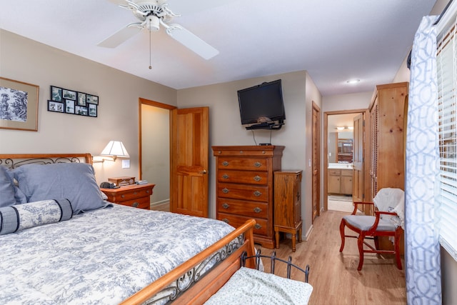 bedroom with light hardwood / wood-style flooring, ceiling fan, and ensuite bathroom