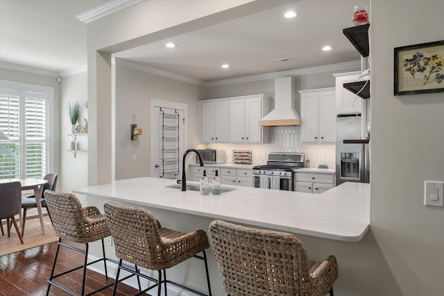 2627 Rutherford Way, Charleston, SC 29414 - kitchen with appliances with stainless steel finishes, custom range hood, a sink, white cabinets, and a breakfast bar area