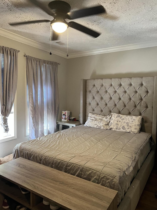 bedroom with ceiling fan, crown molding, and a textured ceiling