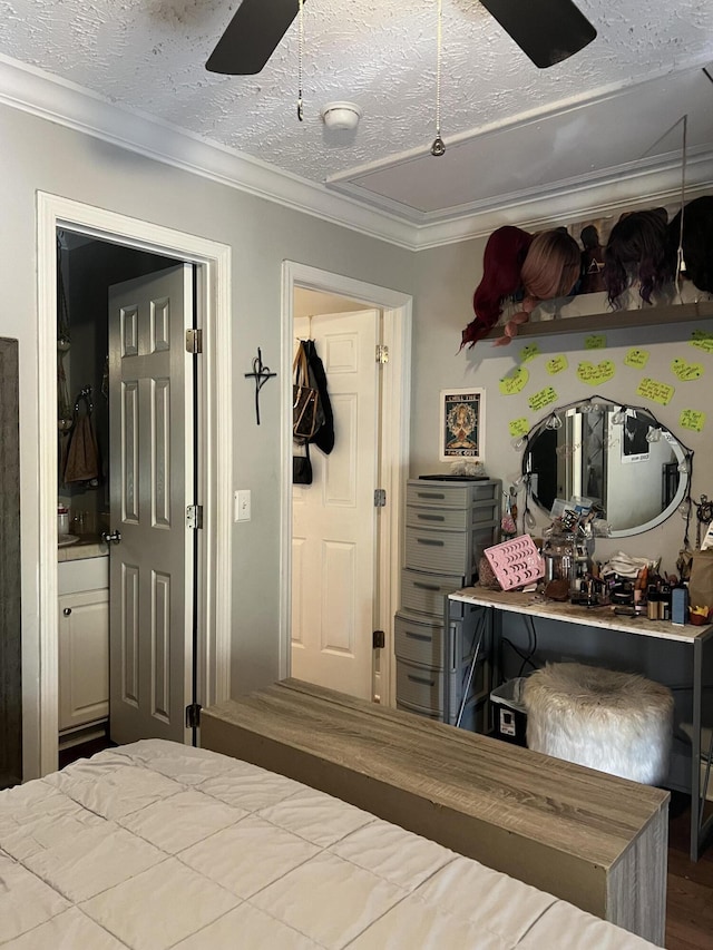 bedroom featuring crown molding, ceiling fan, ensuite bathroom, and a textured ceiling