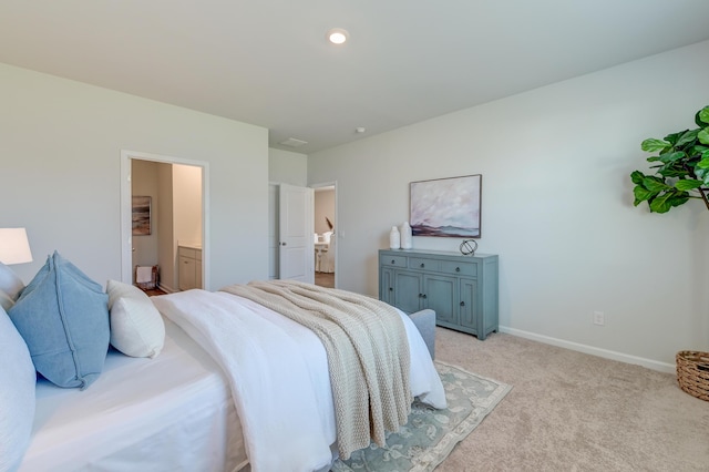 carpeted bedroom featuring ensuite bath