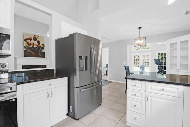 kitchen with visible vents, light tile patterned flooring, glass insert cabinets, white cabinetry, and appliances with stainless steel finishes