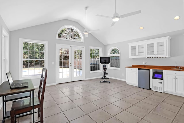 kitchen with french doors, refrigerator, a sink, butcher block counters, and lofted ceiling