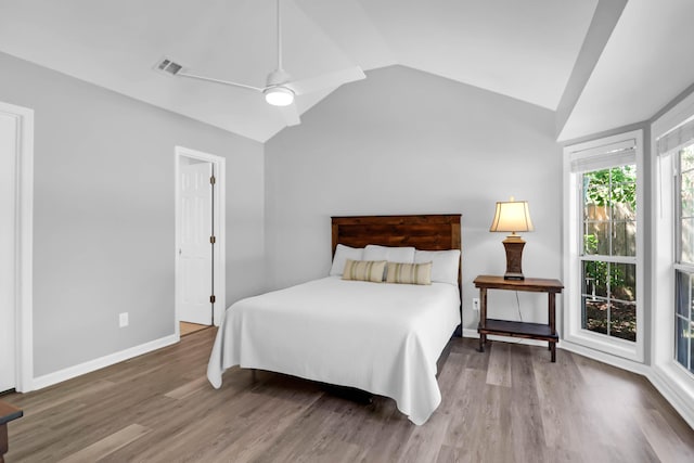bedroom featuring visible vents, a ceiling fan, wood finished floors, and vaulted ceiling